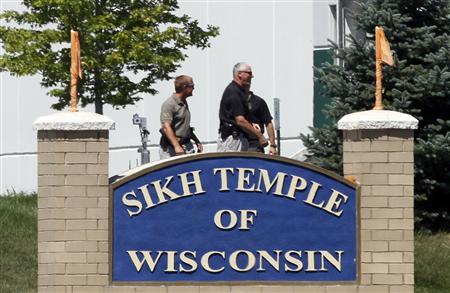 Officials gather near the Sikh Temple in Oak Creek in Wisconsin August 5, 2012 following a mass shooting inside and outside the Sikh Temple. REUTERS/Allen Fredrickson